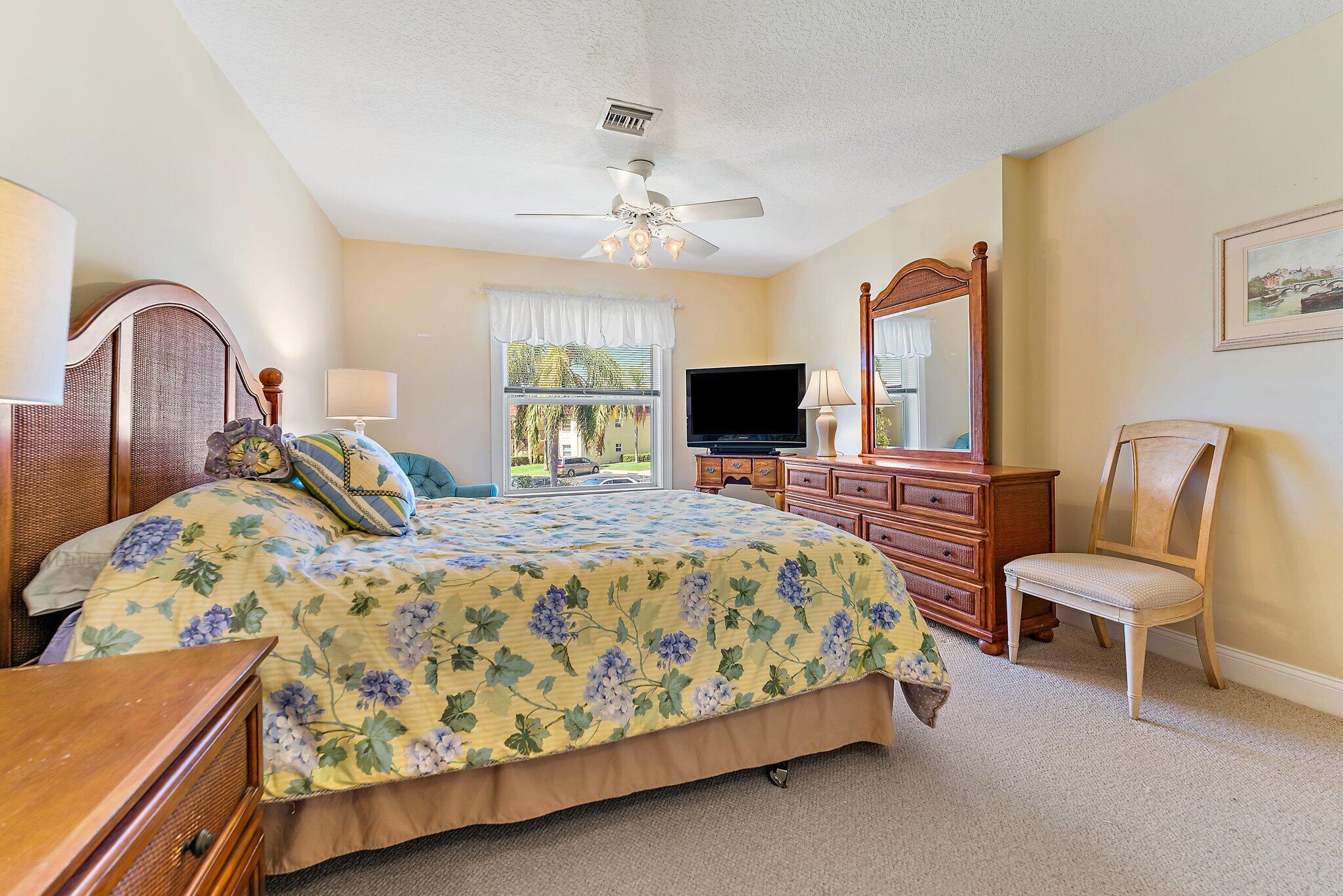 717 Highway 1, Unit 812 Jupiter, FL 33477 - Photo 15 of 41 a bed room with a bed and a chair
