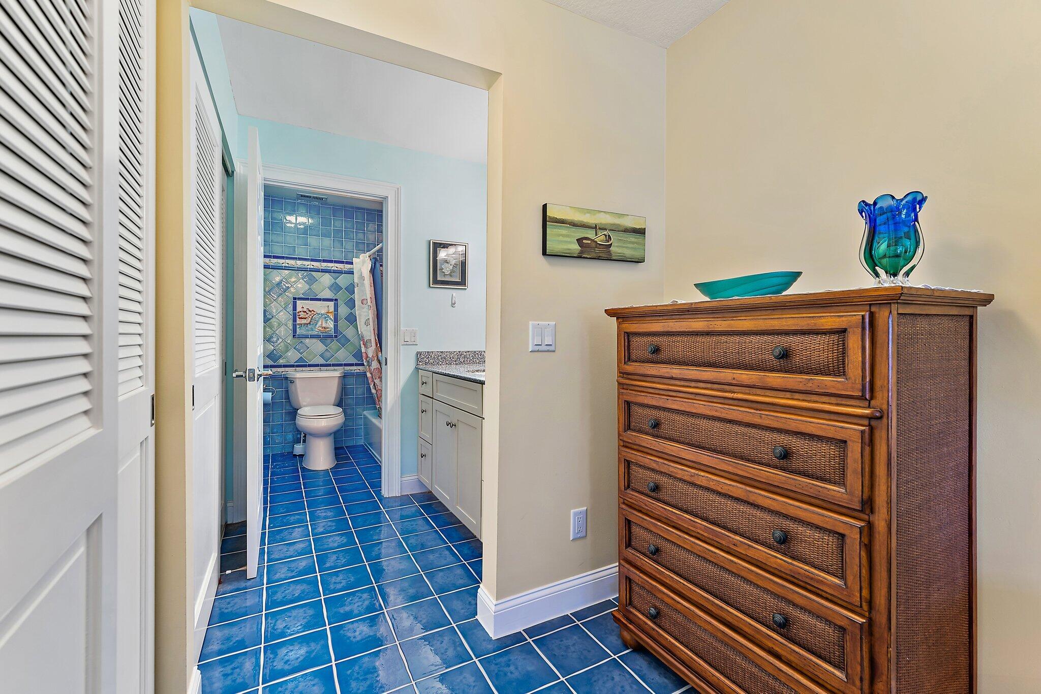 717 Highway 1, Unit 812 Jupiter, FL 33477 - Photo 18 of 41 a view of a hallway with bathroom and wooden floor