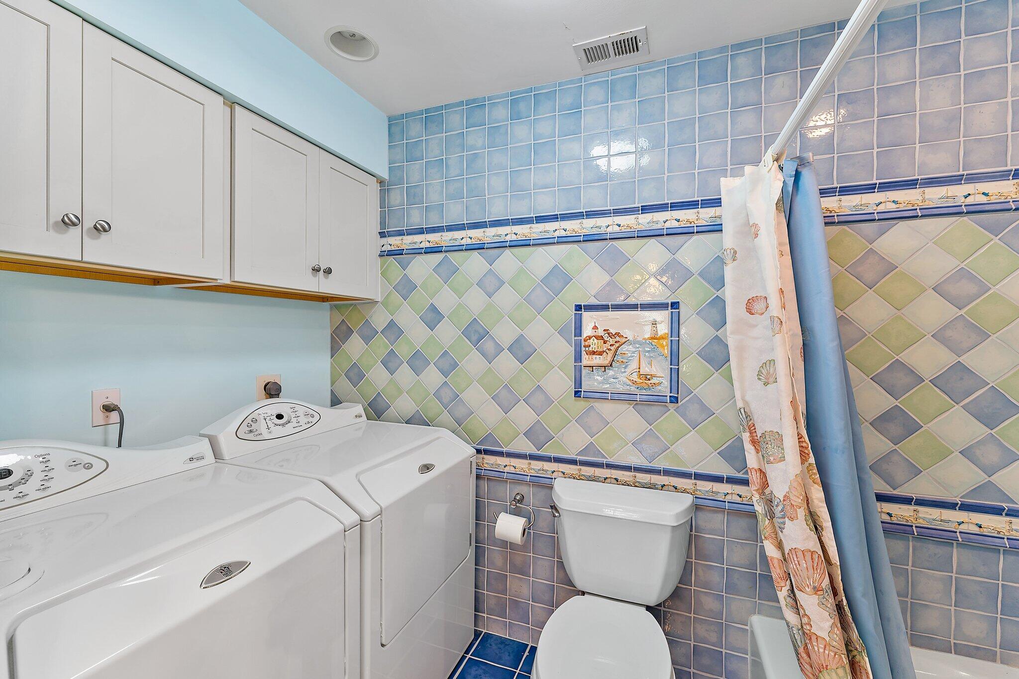 717 Highway 1, Unit 812 Jupiter, FL 33477 - Photo 20 of 41 a bathroom with a sink a toilet and a shower curtain