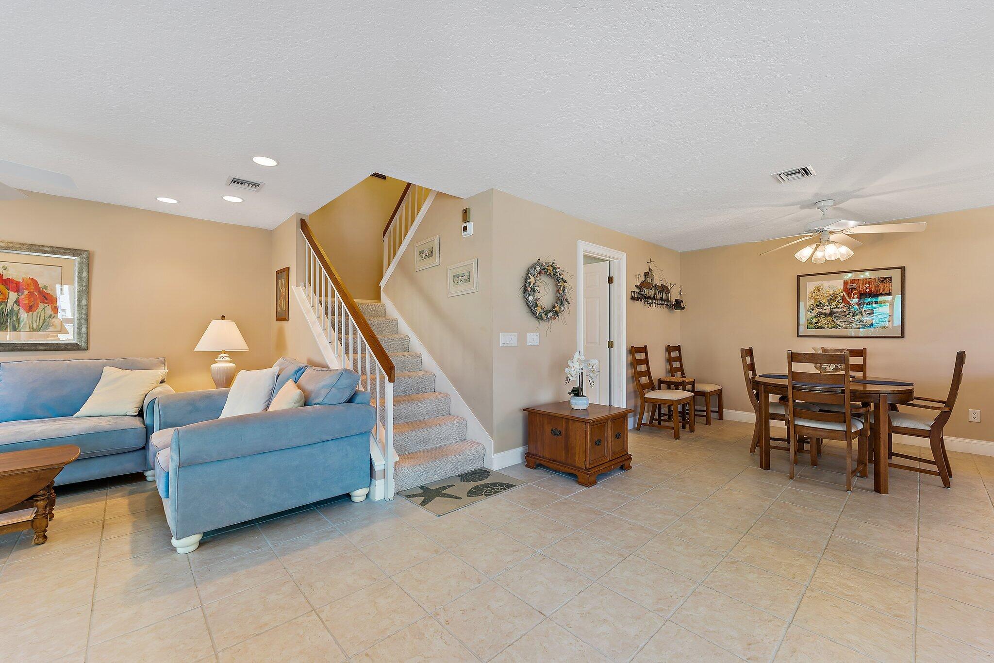 717 Highway 1, Unit 812 Jupiter, FL 33477 - Photo 41 of 41 a living room with furniture and a dining table with projector the screen