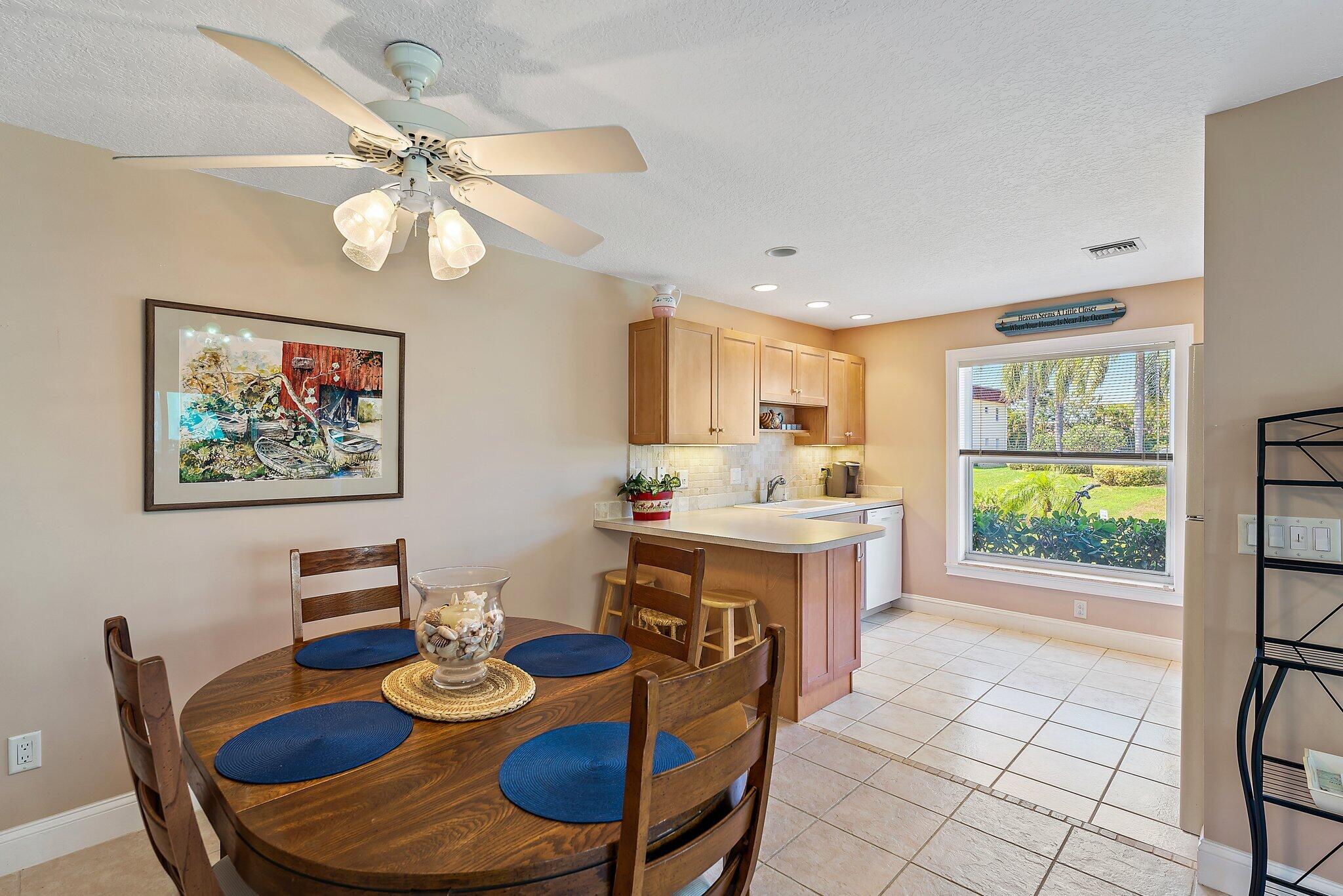 717 Highway 1, Unit 812 Jupiter, FL 33477 - Photo 5 of 41 a view of a dining room with furniture a rug and wooden floor