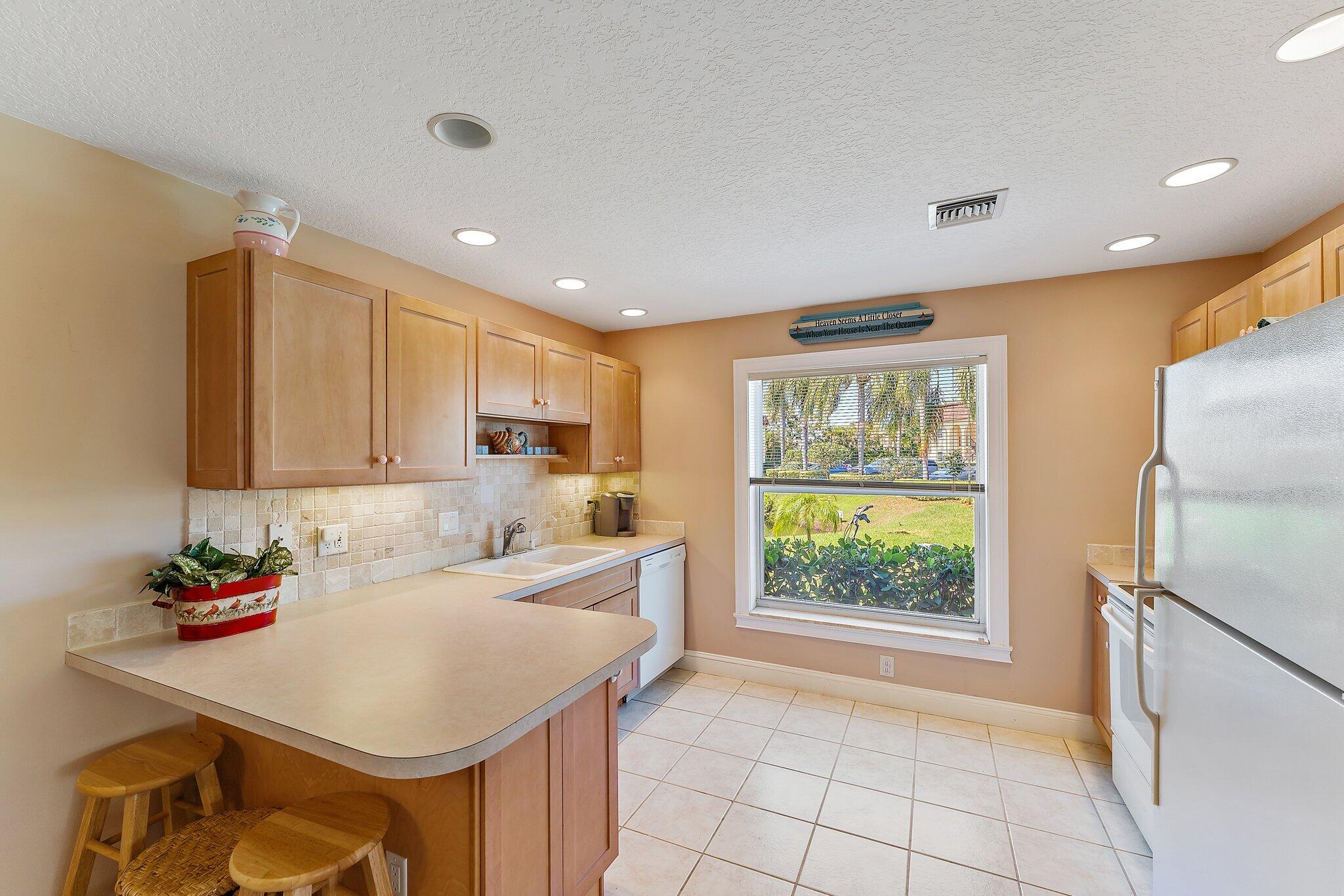 717 Highway 1, Unit 812 Jupiter, FL 33477 - Photo 6 of 41 a kitchen with a sink appliances and cabinets