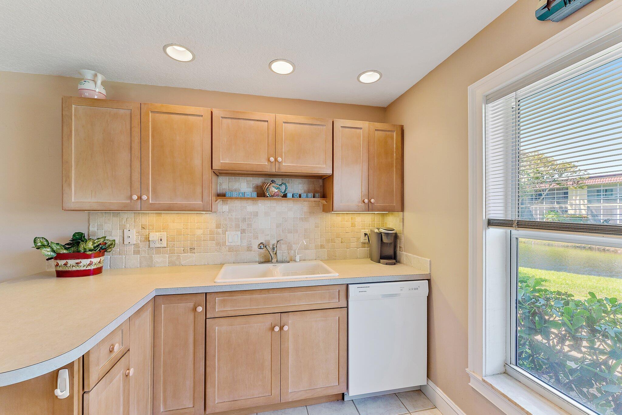 717 Highway 1, Unit 812 Jupiter, FL 33477 - Photo 8 of 41 a kitchen with a sink cabinets and window
