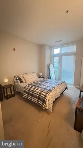 a bedroom with a bed and window