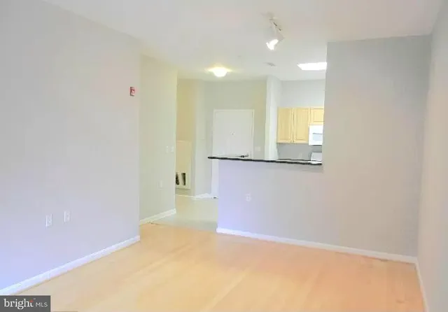 a view of a kitchen with wooden floor