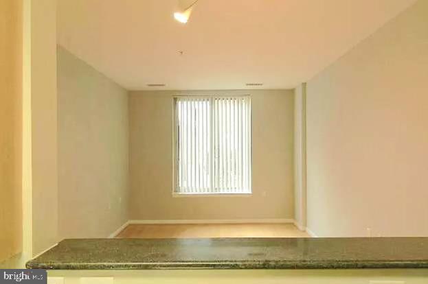 2726 Gallows Road, Unit 110 Vienna, VA 22180 - Photo 20 of 46 a view of a room with wooden floor and a window
