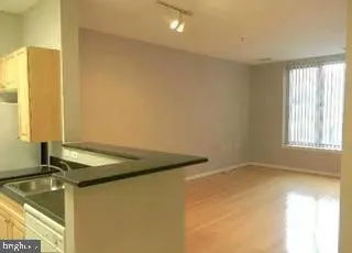 a bathroom with a granite countertop sink and a bathtub