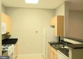 2726 Gallows Road, Unit 110 Vienna, VA 22180 - Photo 29 of 46 a bathroom with a granite countertop sink and a mirror