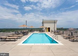 2726 Gallows Road, Unit 110 Vienna, VA 22180 - Photo 33 of 46 a view of swimming pool with outdoor seating and city view