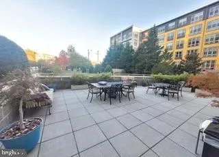 a view of a patio with dining table and chairs