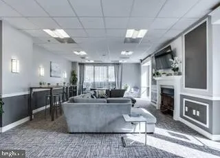 a living room with fireplace furniture and a fireplace