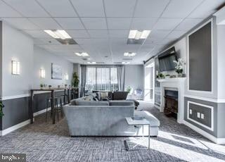 2726 Gallows Road, Unit 110 Vienna, VA 22180 - Photo 42 of 46 a living room with fireplace furniture and a fireplace