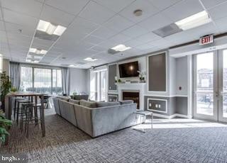 2726 Gallows Road, Unit 110 Vienna, VA 22180 - Photo 43 of 46 a living room with furniture a fireplace and a flat screen tv