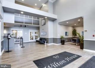 2726 Gallows Road, Unit 110 Vienna, VA 22180 - Photo 45 of 46 a living room with lots of furniture and kitchen view