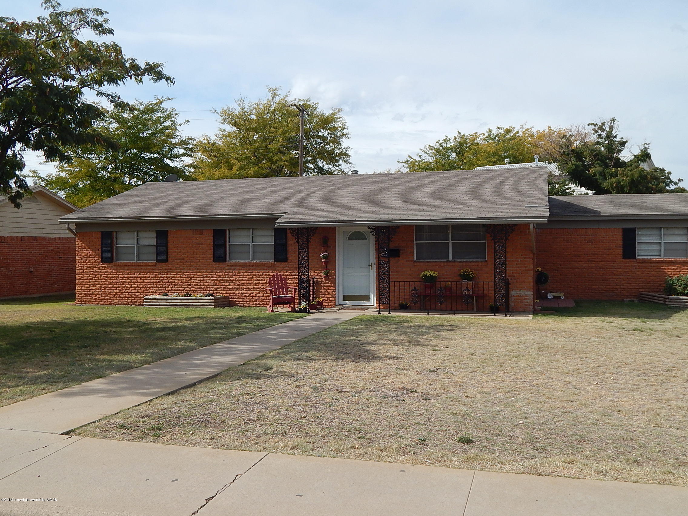 4700 South Milam Street Amarillo, TX 79110 - Photo 1 of 17 a front view of a house with a garden