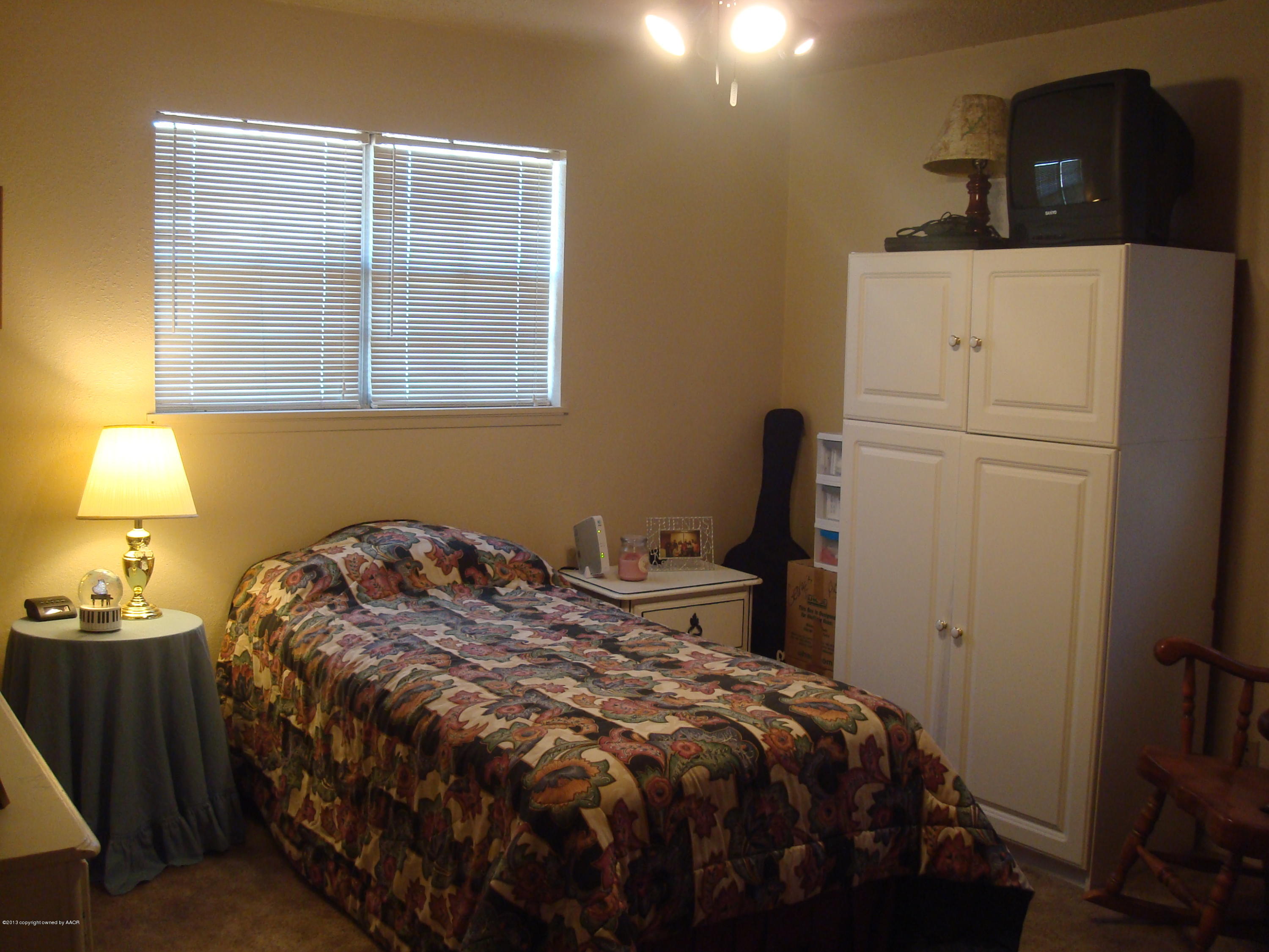 4700 South Milam Street Amarillo, TX 79110 - Photo 12 of 17 a bedroom with a bed and a window