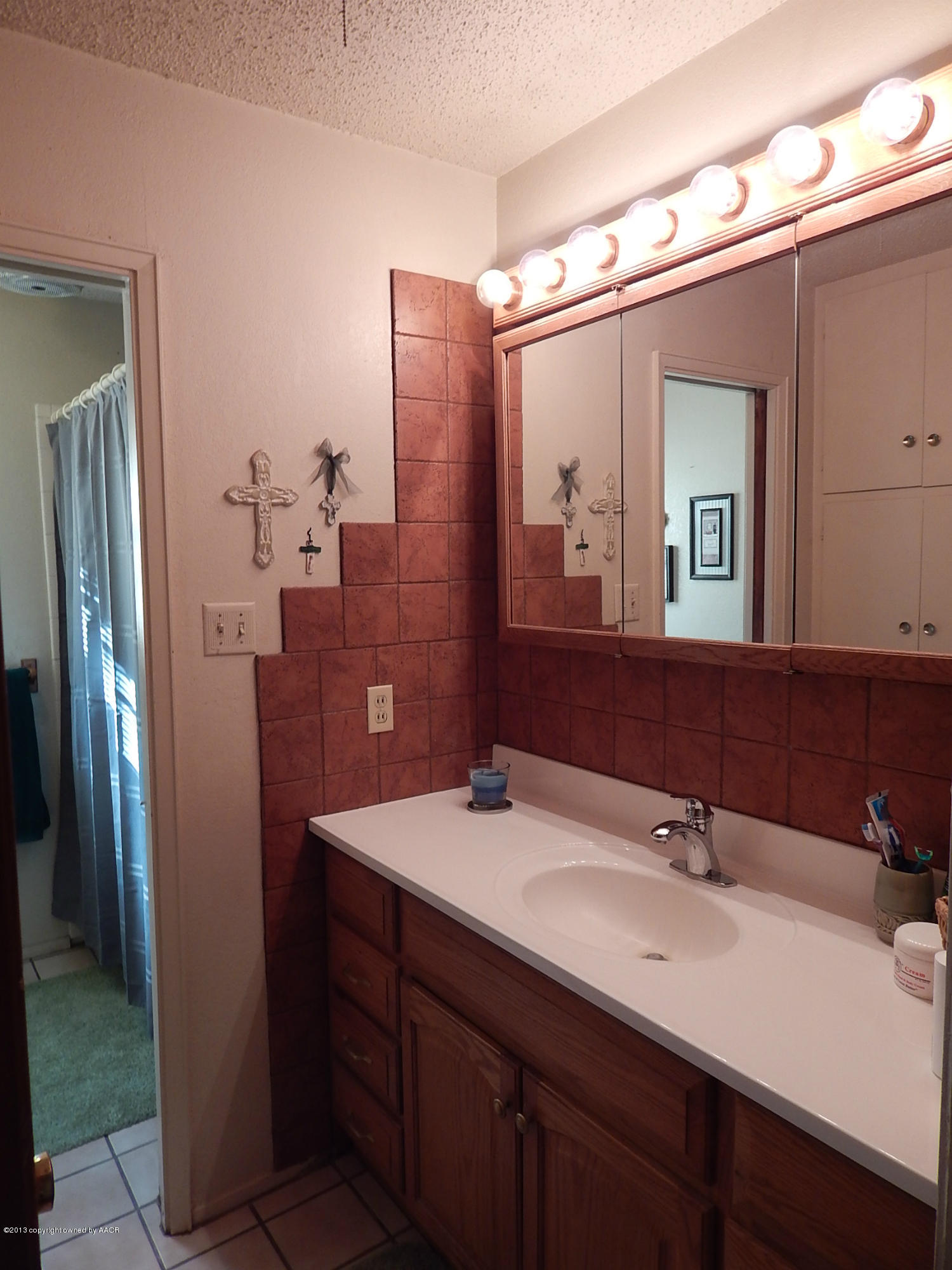 4700 South Milam Street Amarillo, TX 79110 - Photo 13 of 17 a bathroom with a double vanity sink and mirror