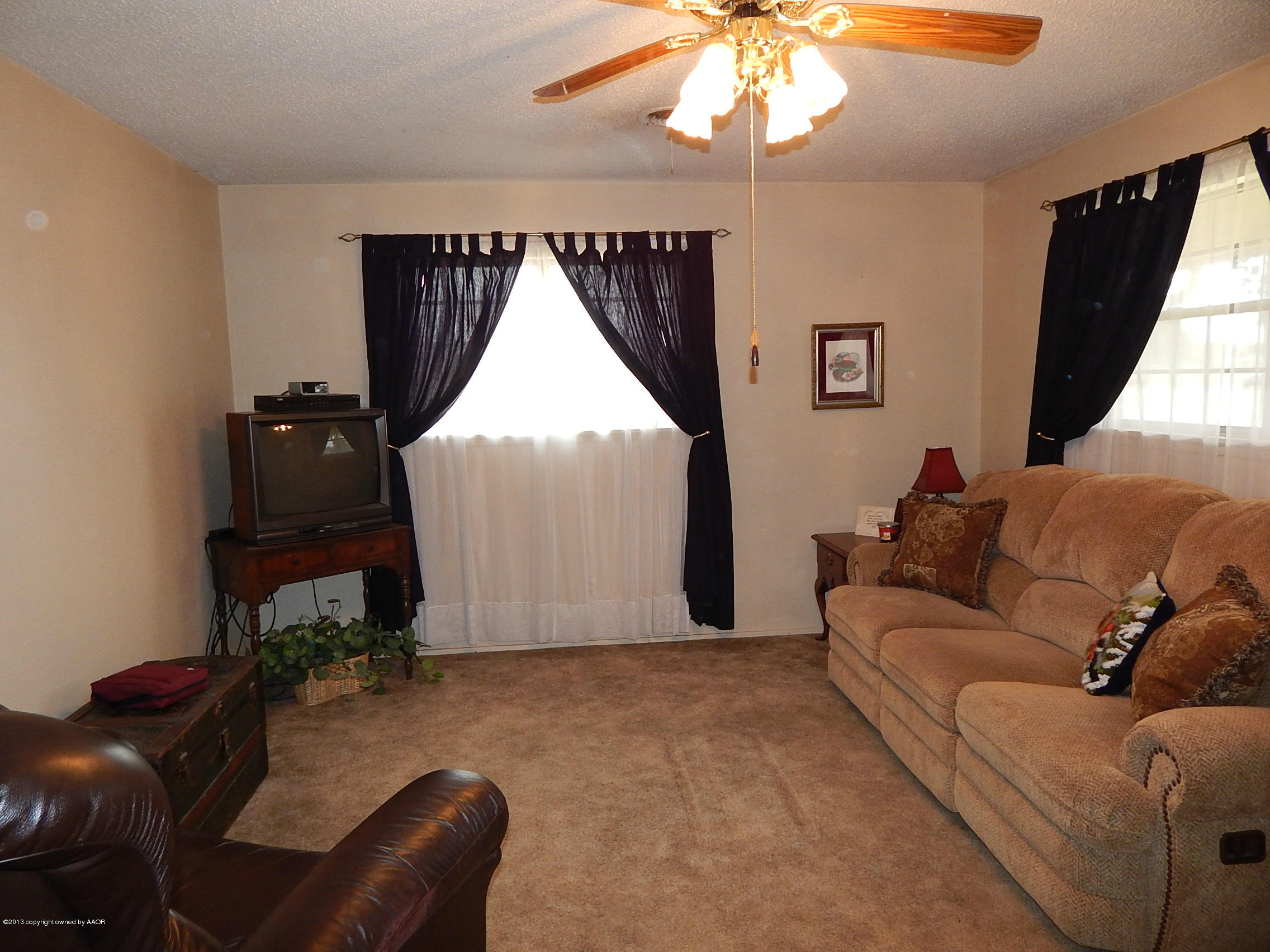 4700 South Milam Street Amarillo, TX 79110 - Photo 4 of 17 a living room with furniture and a chandelier