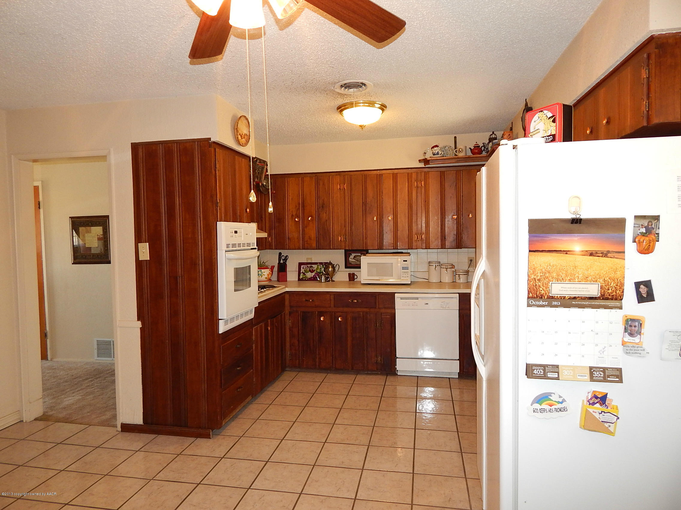 4700 South Milam Street Amarillo, TX 79110 - Photo 6 of 17 a kitchen with stainless steel appliances granite countertop a refrigerator and a sink