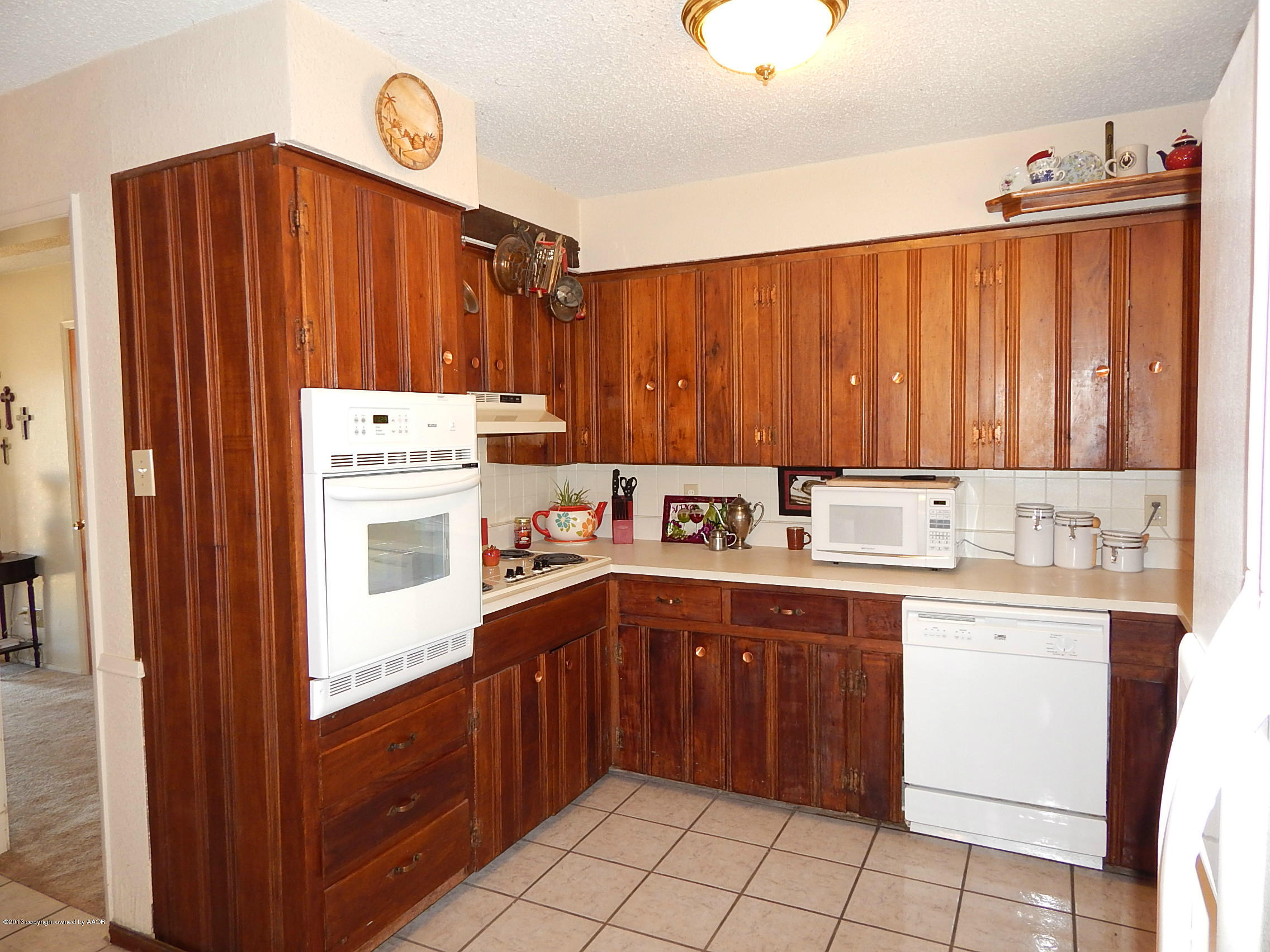 4700 South Milam Street Amarillo, TX 79110 - Photo 9 of 17 a kitchen with a sink and cabinets