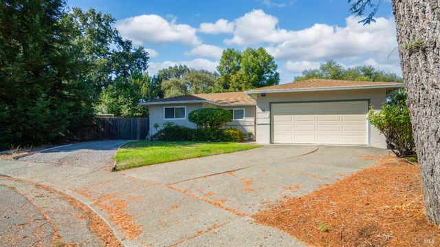 a front view of a house with a yard and a garage