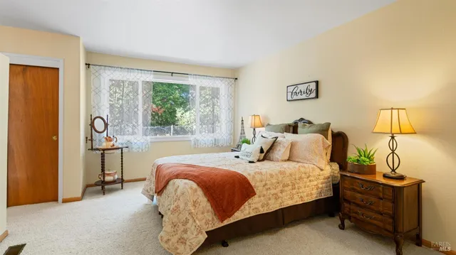 a view of a backyard with table and chairs and potted plants