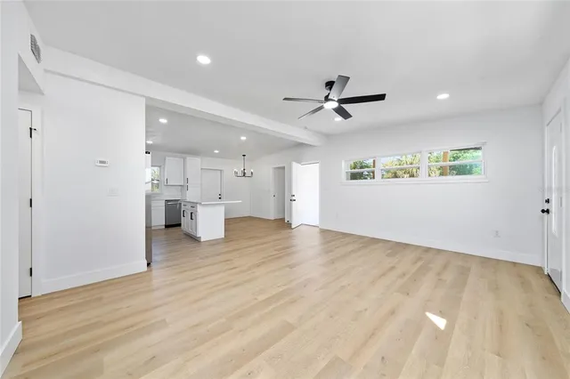 a view of a kitchen with a sink and a refrigerator