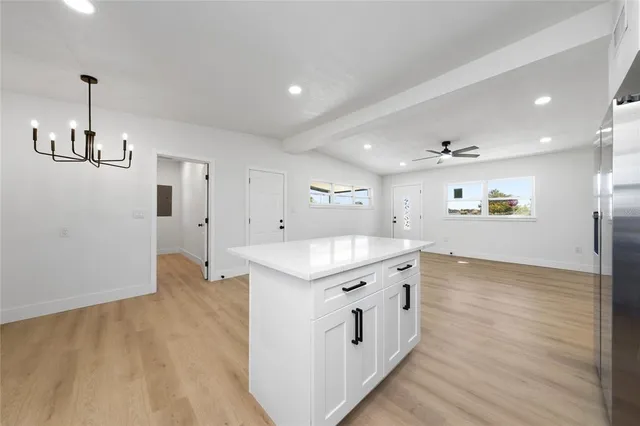 a kitchen with stainless steel appliances granite countertop a sink and refrigerator