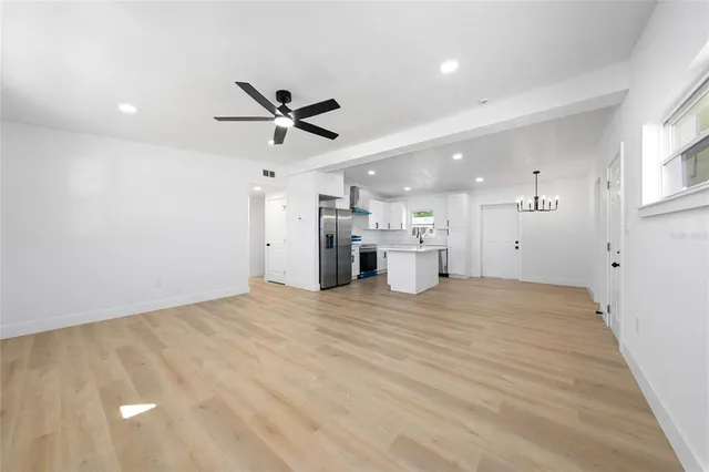 a view of a kitchen with a sink and a refrigerator