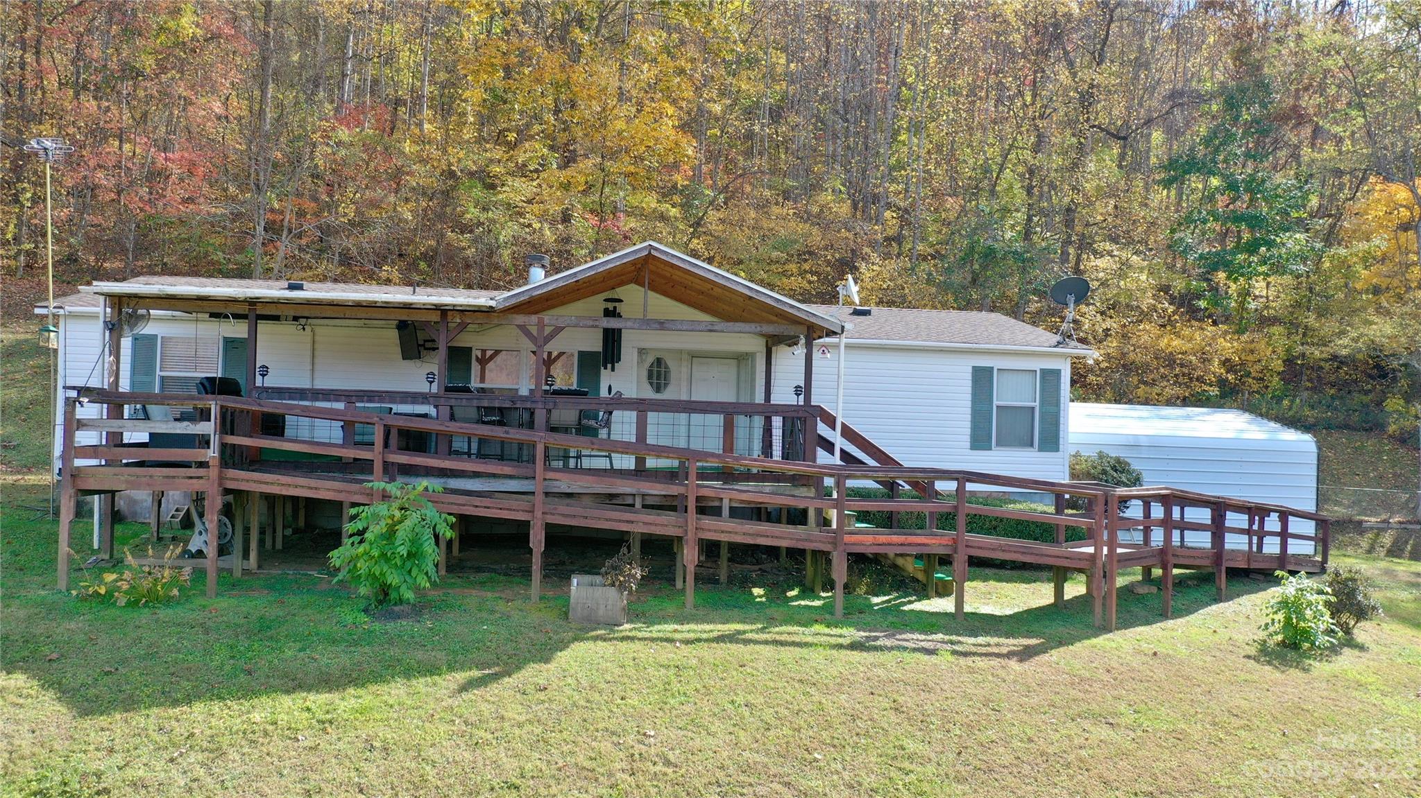 170 Painter Street Sylva, NC 28779 - Photo 38 of 48 a view of a house with a wooden deck and a yard