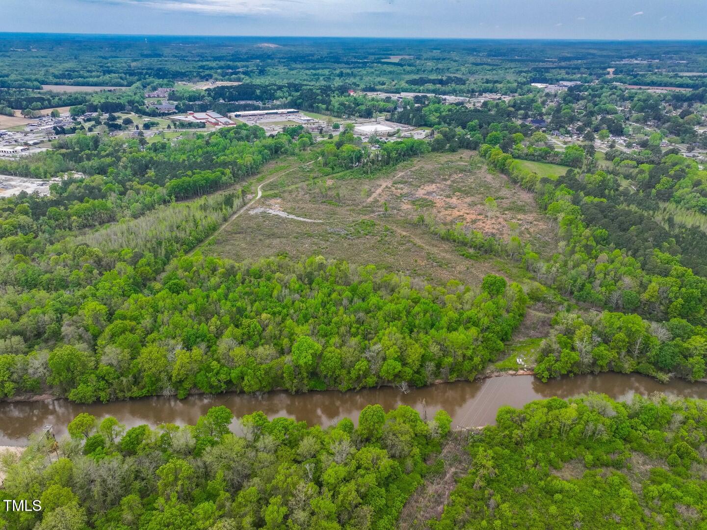 0 Wilsons Mills Road Smithfield, NC 27577 - Photo 11 of 15 a view of a lake with a field and trees