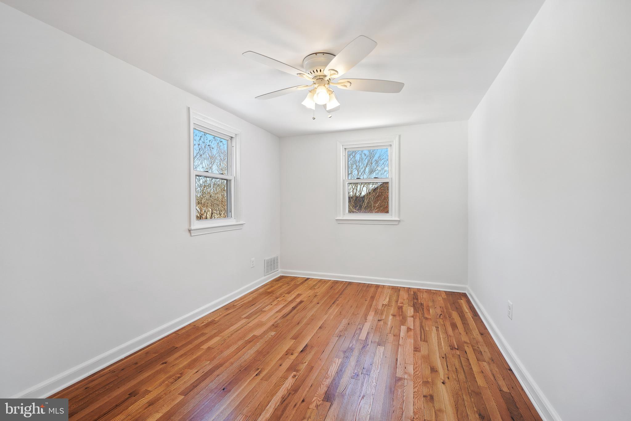 2707 Harmon Road Silver Spring, MD 20902 - Photo 14 of 22 a view of a room with wooden floor and a ceiling fan