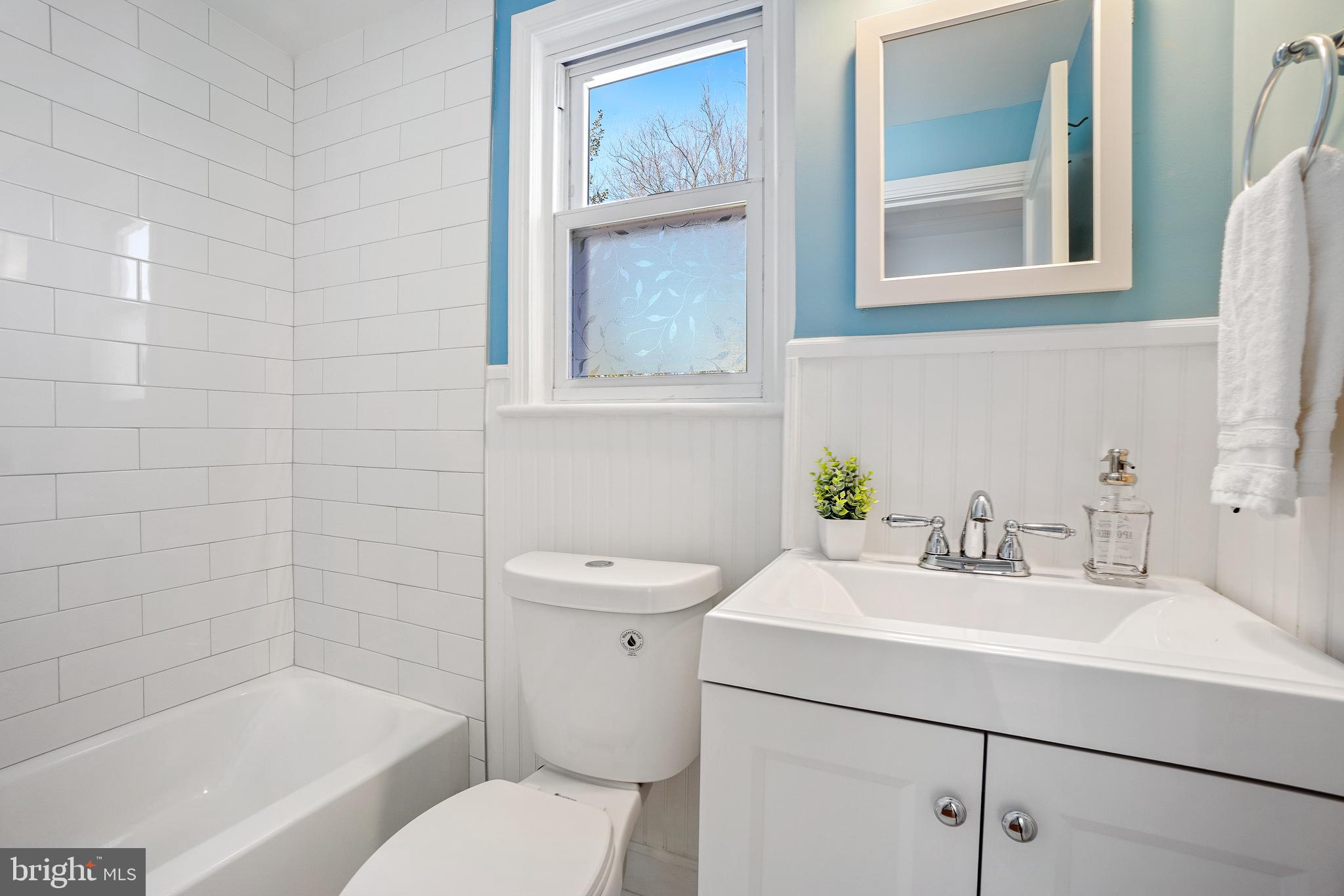 2707 Harmon Road Silver Spring, MD 20902 - Photo 16 of 22 a bathroom with a sink mirror vanity and toilet