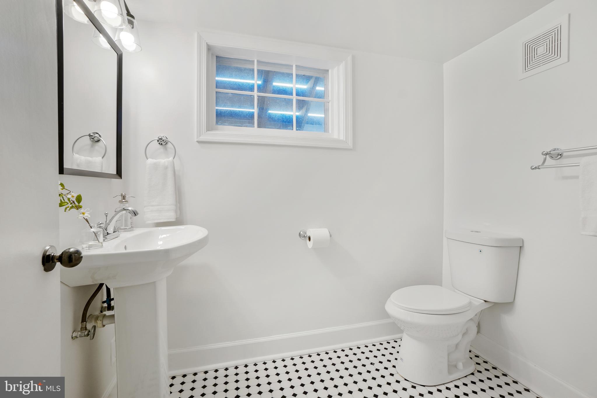 2707 Harmon Road Silver Spring, MD 20902 - Photo 20 of 22 a bathroom with a sink toilet and a mirror