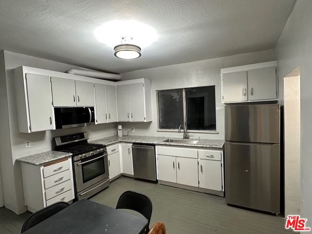 a kitchen with a refrigerator stove and microwave
