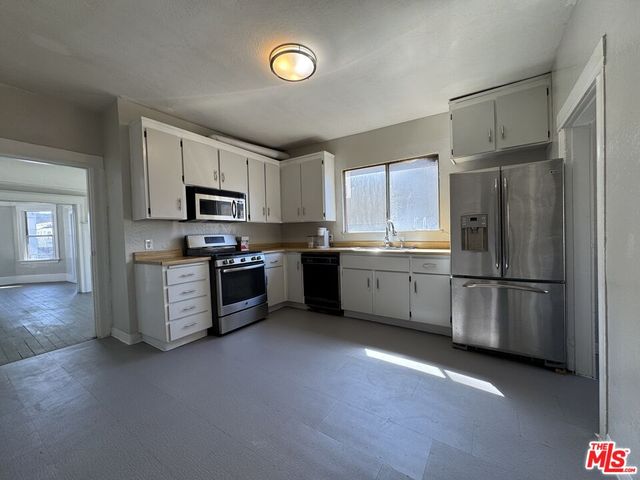 a kitchen with a refrigerator a sink and cabinets
