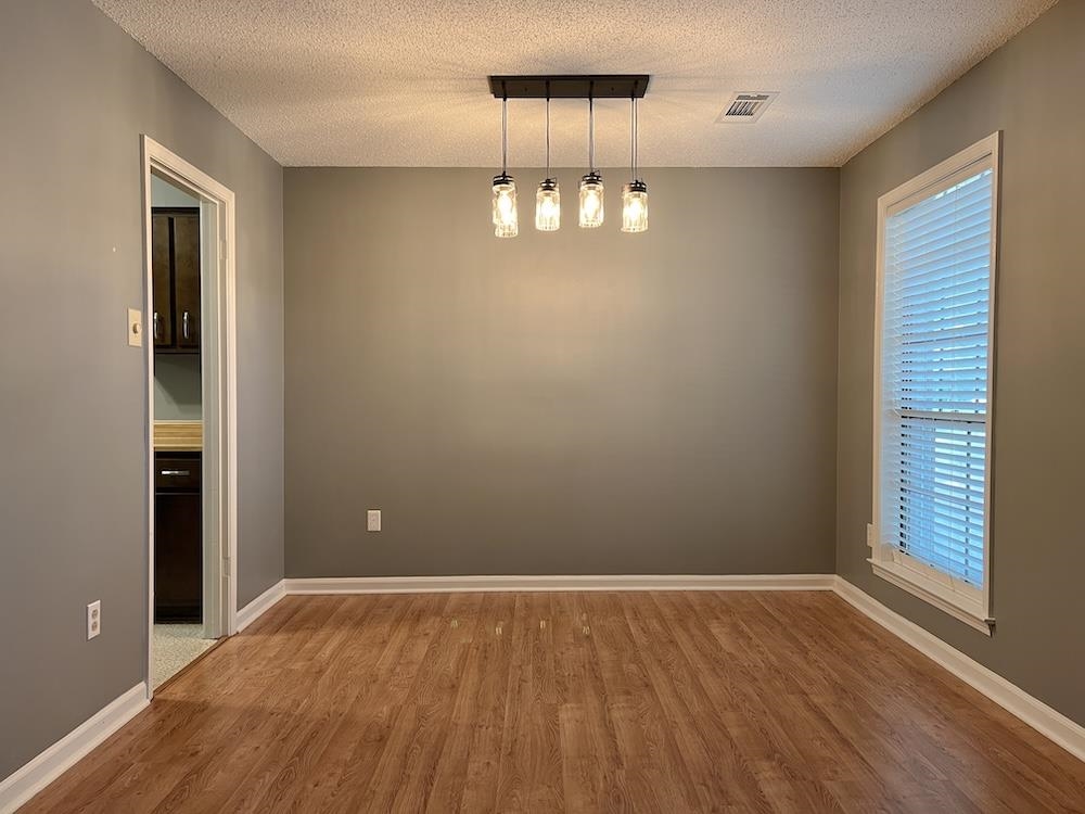 7935 Memphis Arlington Road Bartlett, TN 38133 - Photo 9 of 20 Spacious room featuring wood-finish flooring, neutral gray walls, and white baseboards