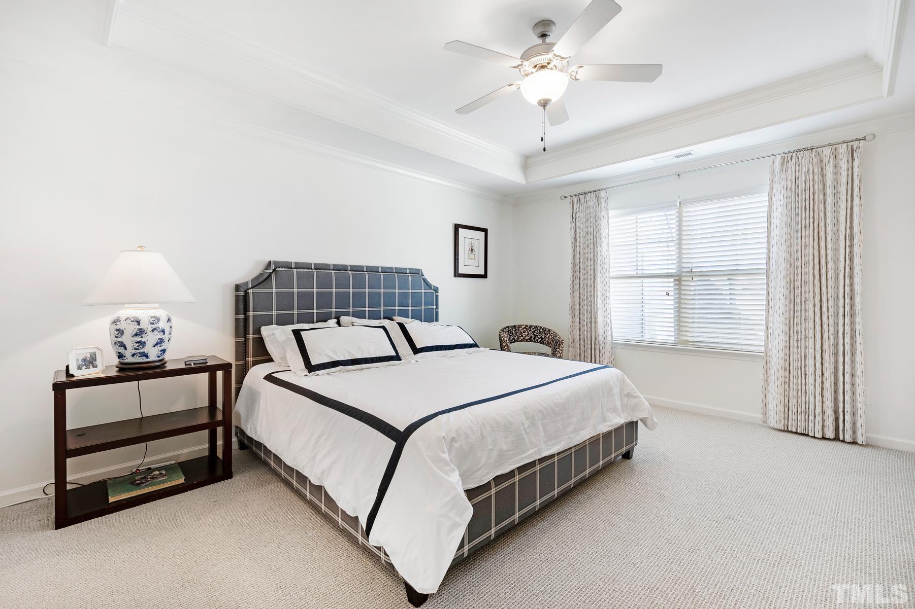 2307 Lowden Street Raleigh, NC 27608 - Photo 7 of 10 a bedroom with a bed and a chandelier