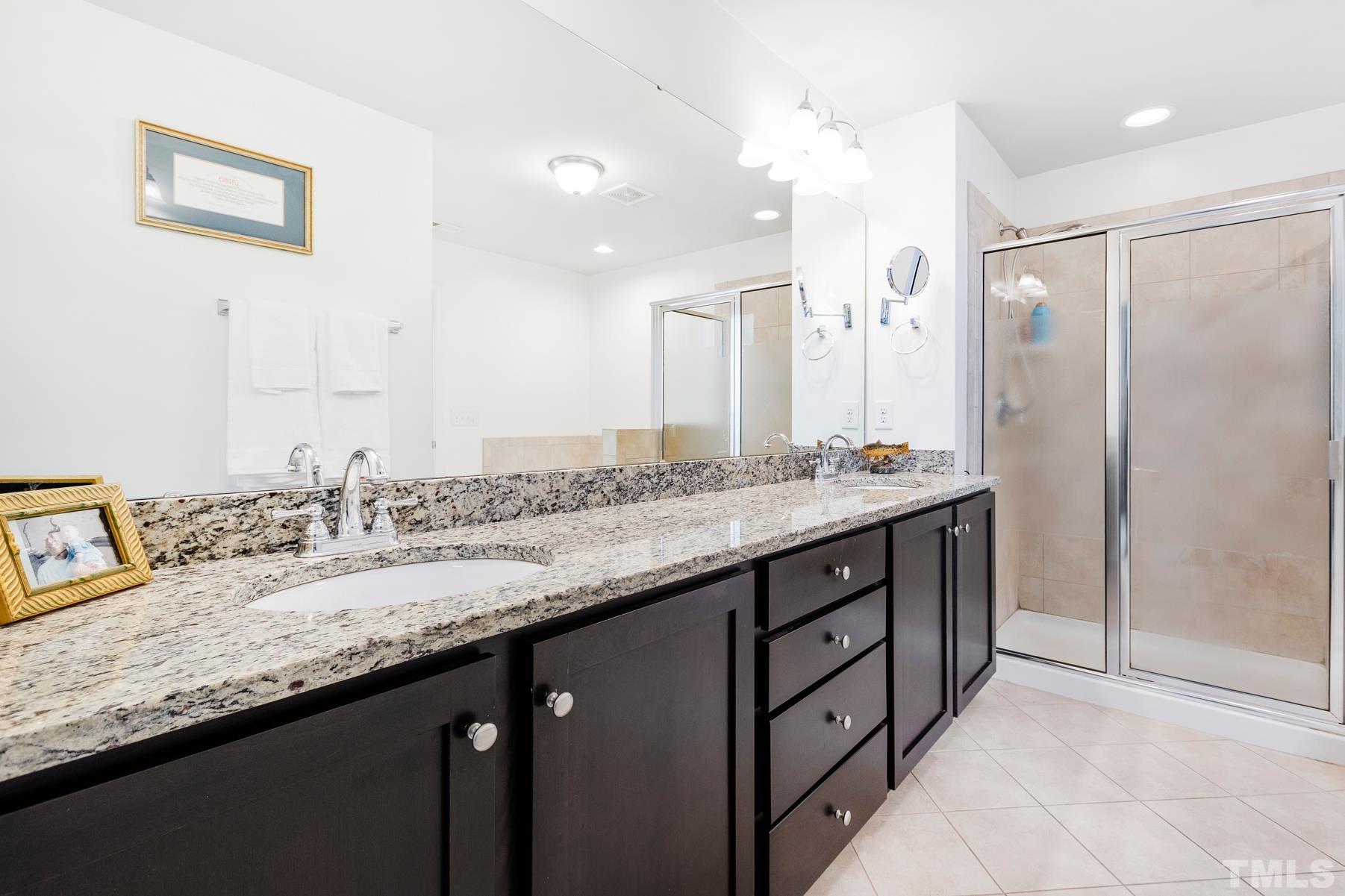 2307 Lowden Street Raleigh, NC 27608 - Photo 8 of 10 a bathroom with a granite countertop sink two mirror and a