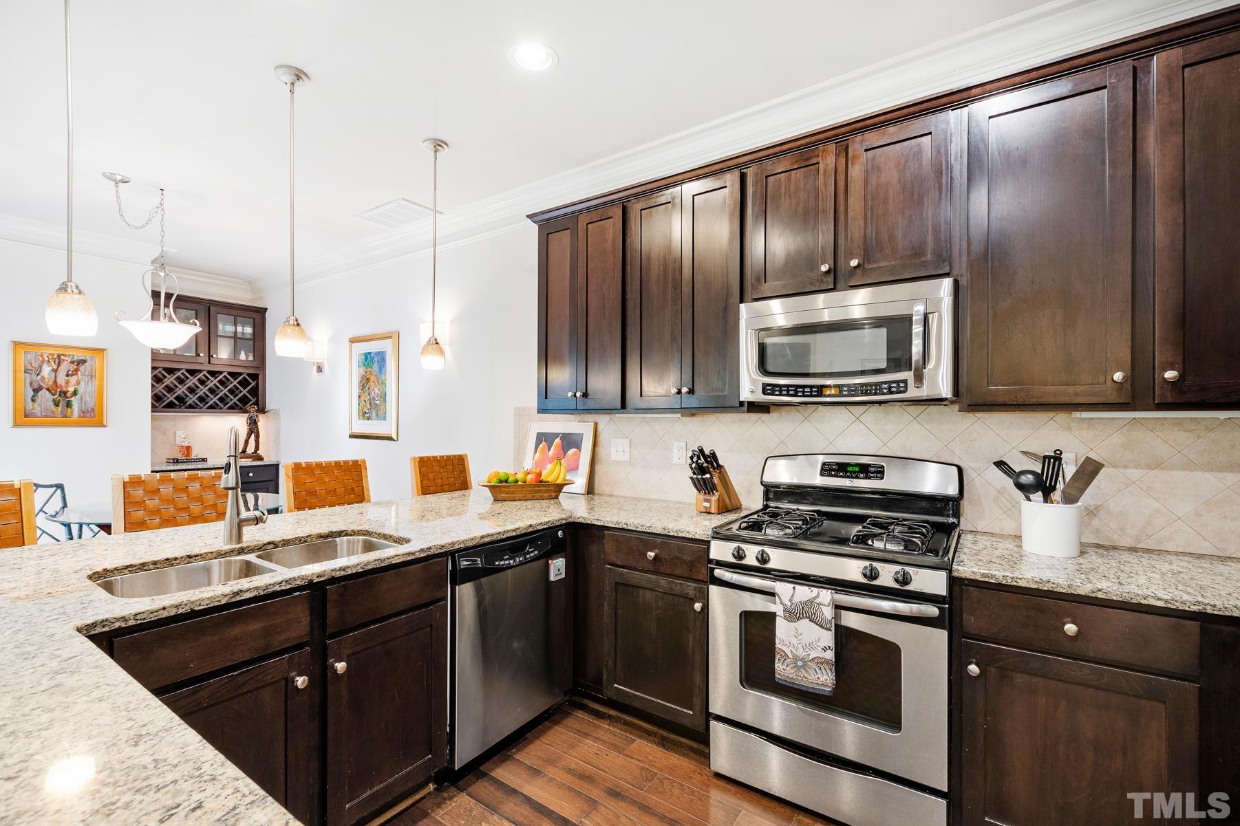 2307 Lowden Street Raleigh, NC 27608 - Photo 10 of 10 a kitchen with stainless steel appliances a sink stove and microwave