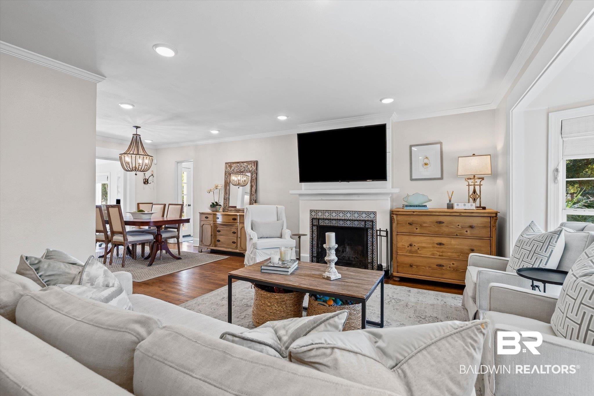 4310 The Cedars Avenue Mobile, AL 36608 - Photo 5 of 32 Living area featuring a fireplace, wood finished floors, crown molding, recessed lighting, and a chandelier