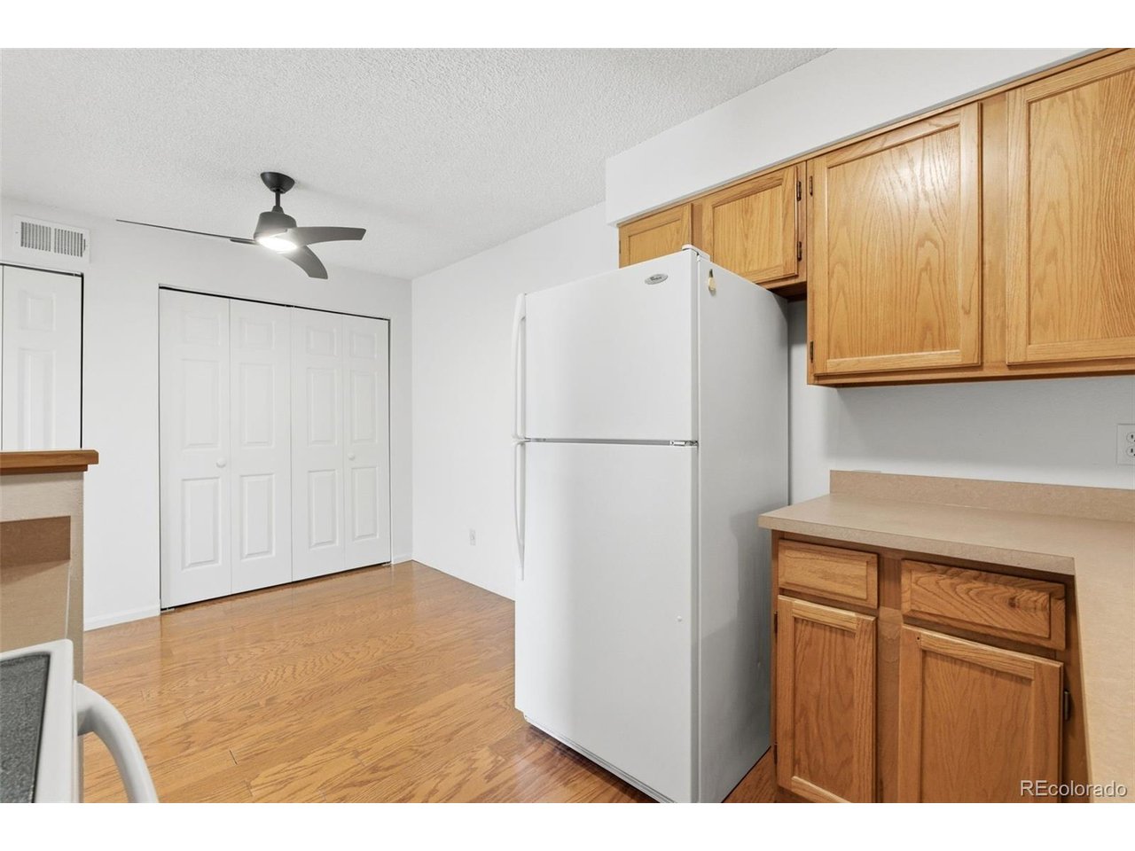 10251 West 44th Avenue, Unit 208 Wheat Ridge, CO 80033 - Photo 12 of 28 a bathroom with a refrigerator and a sink