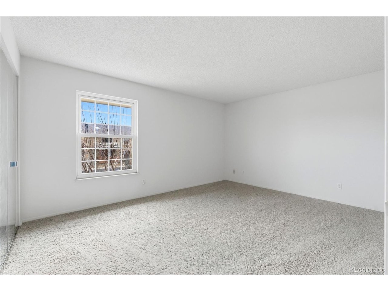 10251 West 44th Avenue, Unit 208 Wheat Ridge, CO 80033 - Photo 14 of 28 an empty room with a window