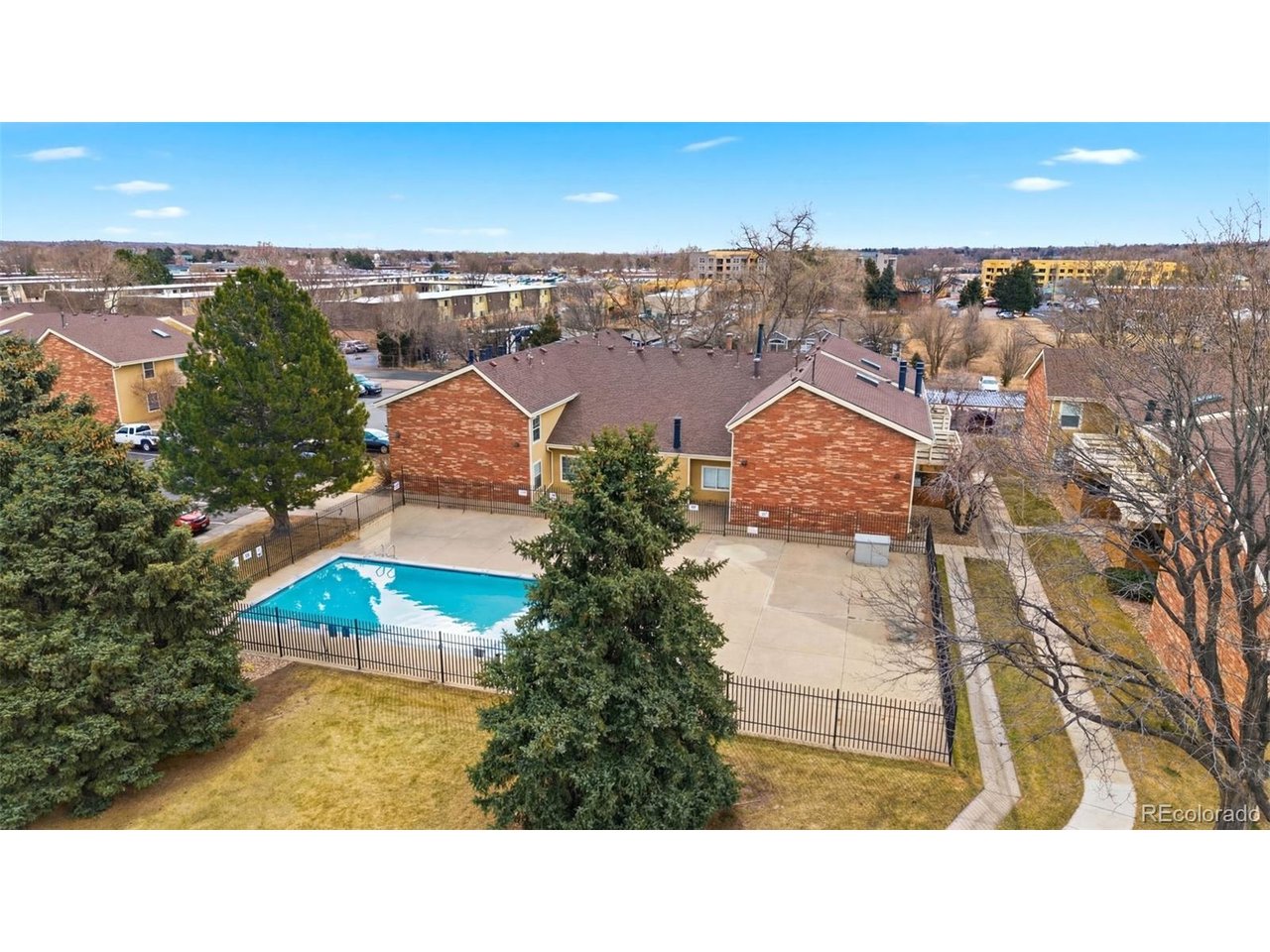 10251 West 44th Avenue, Unit 208 Wheat Ridge, CO 80033 - Photo 26 of 28 an aerial view of residential houses with outdoor space and swimming pool