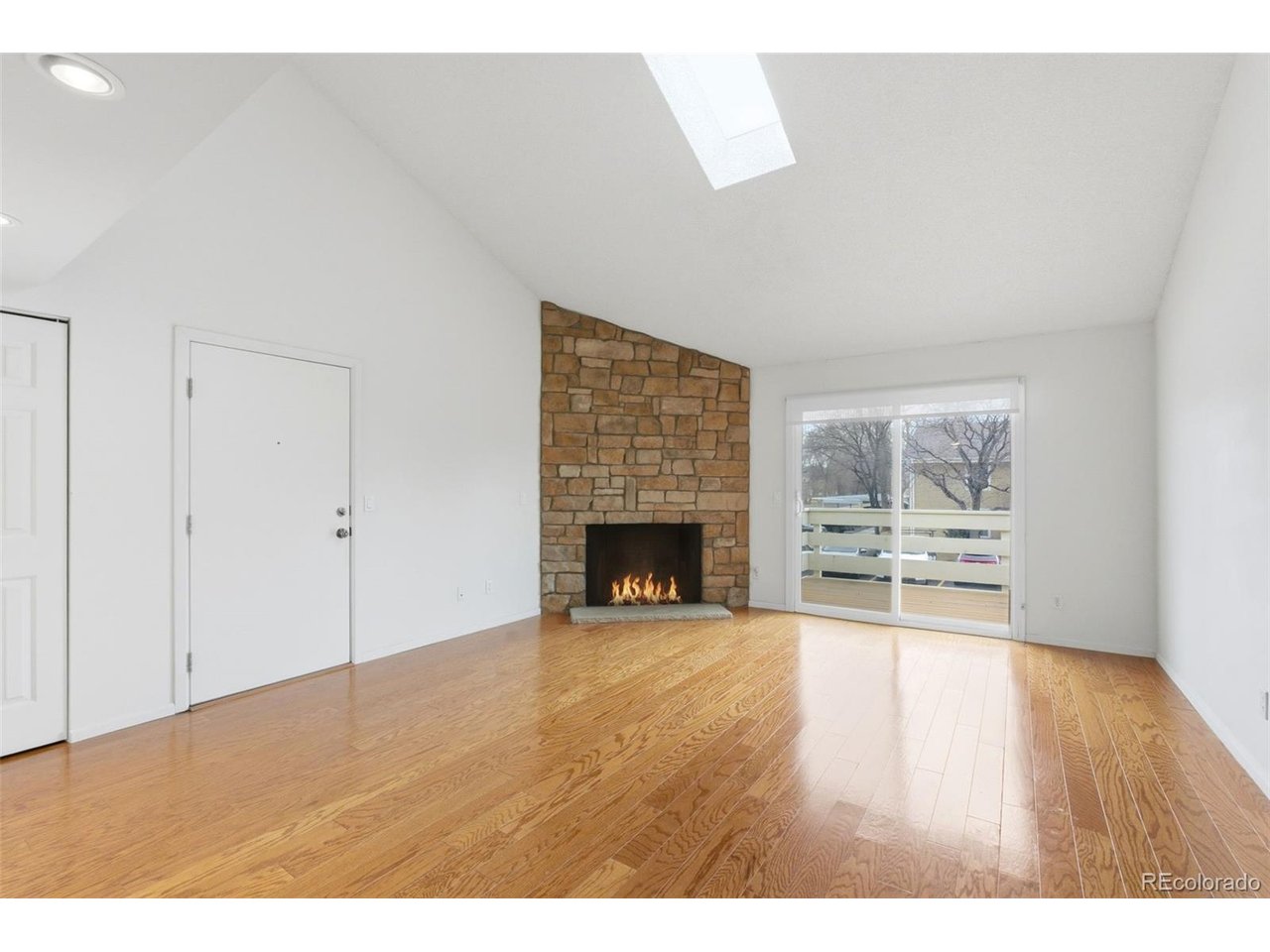10251 West 44th Avenue, Unit 208 Wheat Ridge, CO 80033 - Photo 3 of 28 a view of an empty room with a fireplace and window
