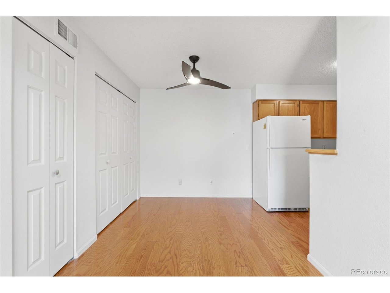 10251 West 44th Avenue, Unit 208 Wheat Ridge, CO 80033 - Photo 7 of 28 a view of empty room with wooden floor