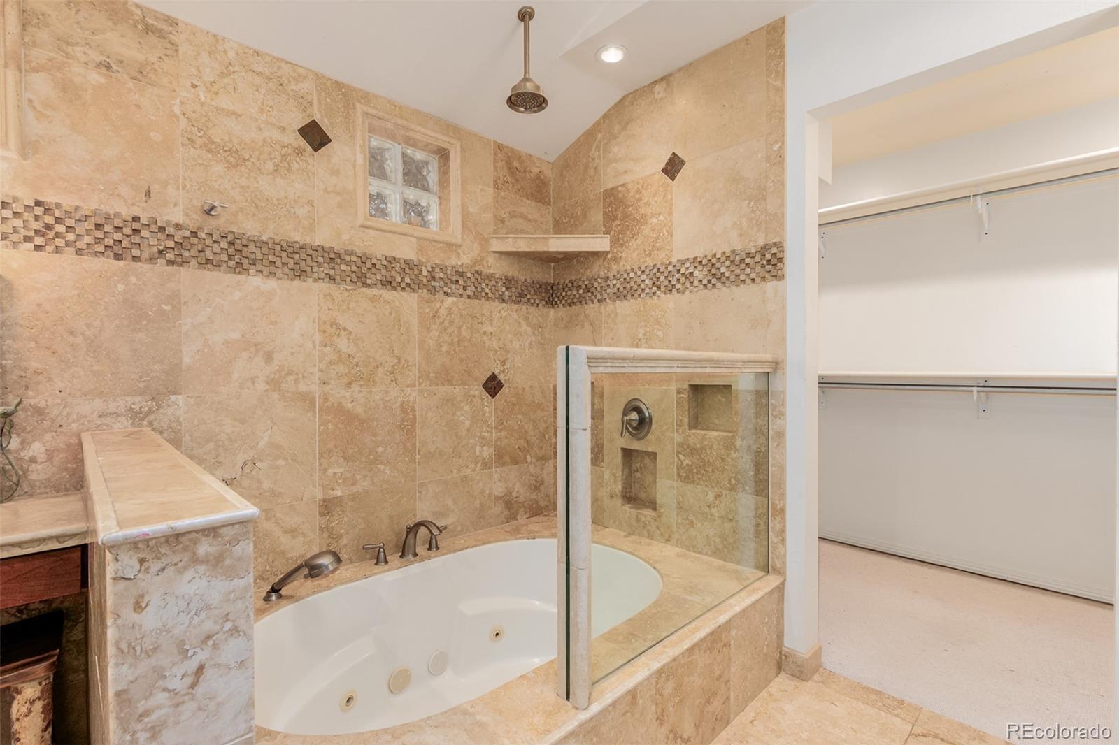 200 East Caley Avenue Centennial, CO 80121 - Photo 19 of 49 a bathroom with a tub and shower