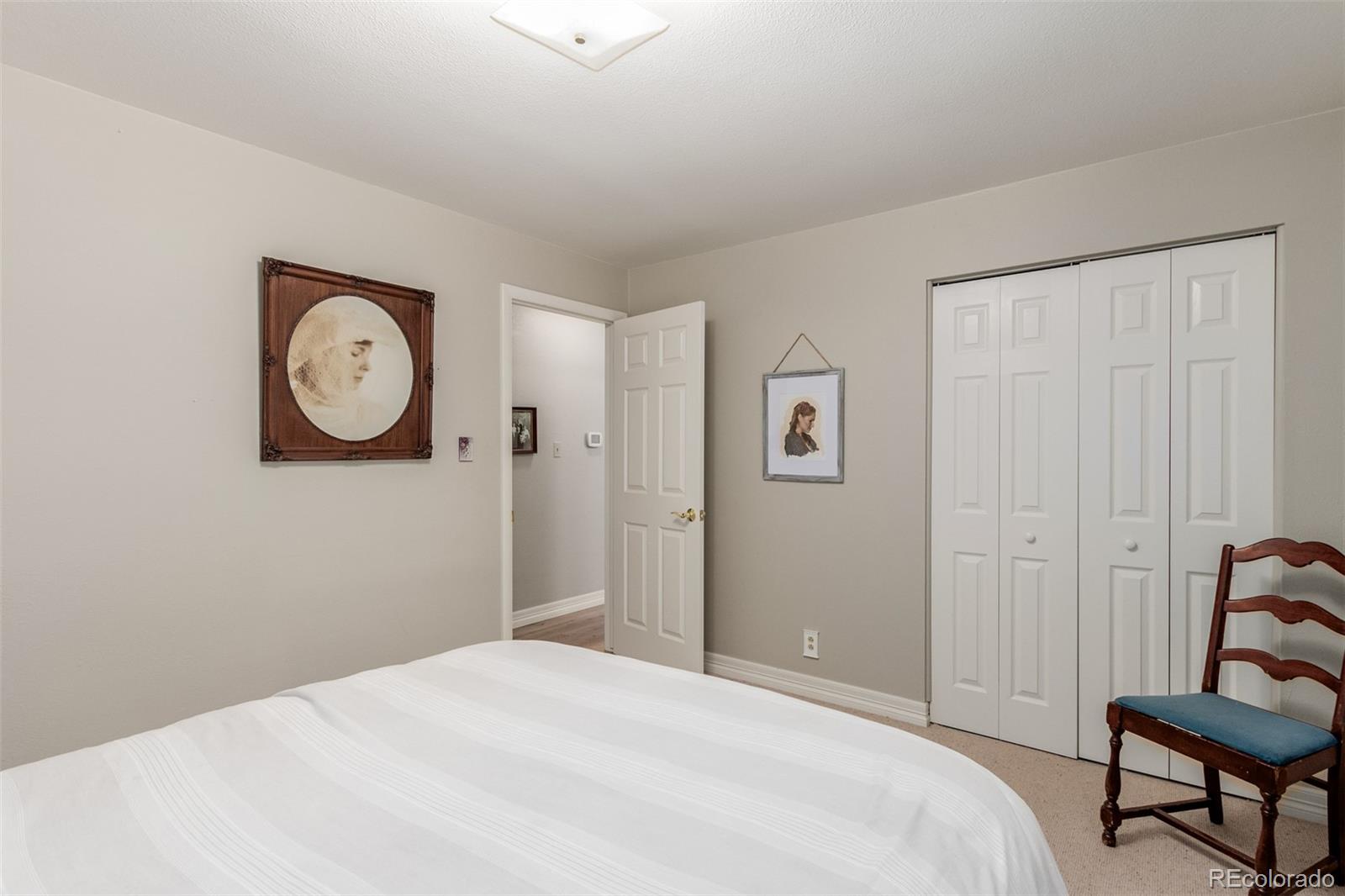 200 East Caley Avenue Centennial, CO 80121 - Photo 24 of 49 a bedroom with a bed and a wall painting