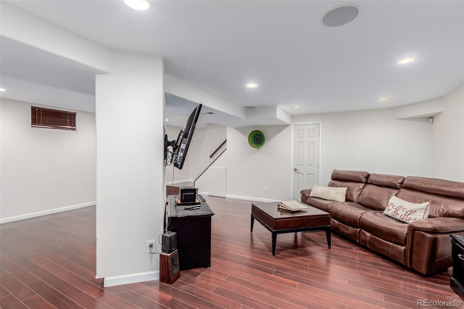 200 East Caley Avenue Centennial, CO 80121 - Photo 31 of 49 a living room with furniture and a wooden floor