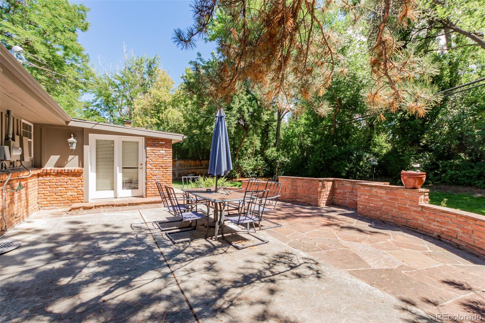 200 East Caley Avenue Centennial, CO 80121 - Photo 36 of 49 a view of backyard with a table and chairs and wooden fence